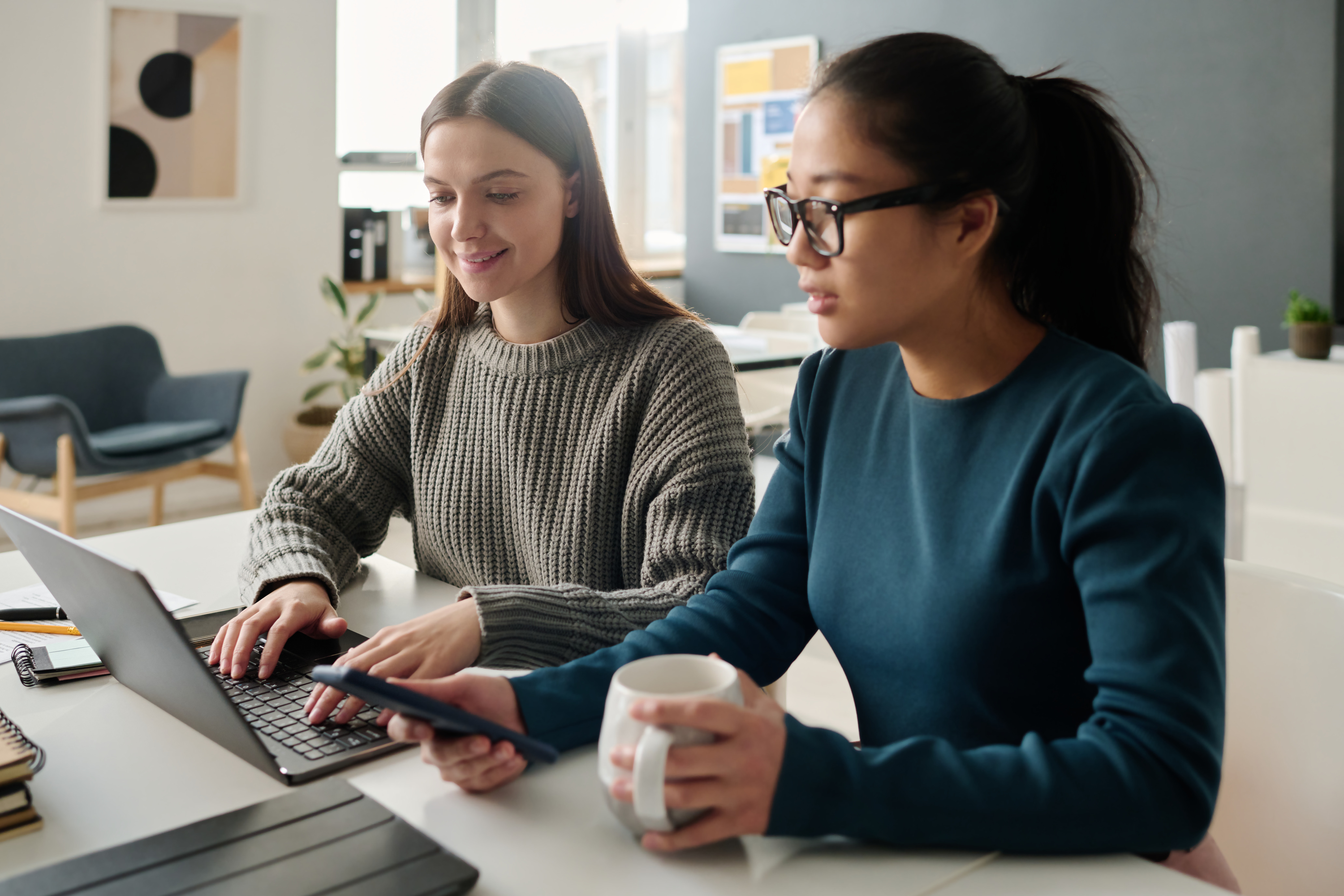 Two Women Working In Office