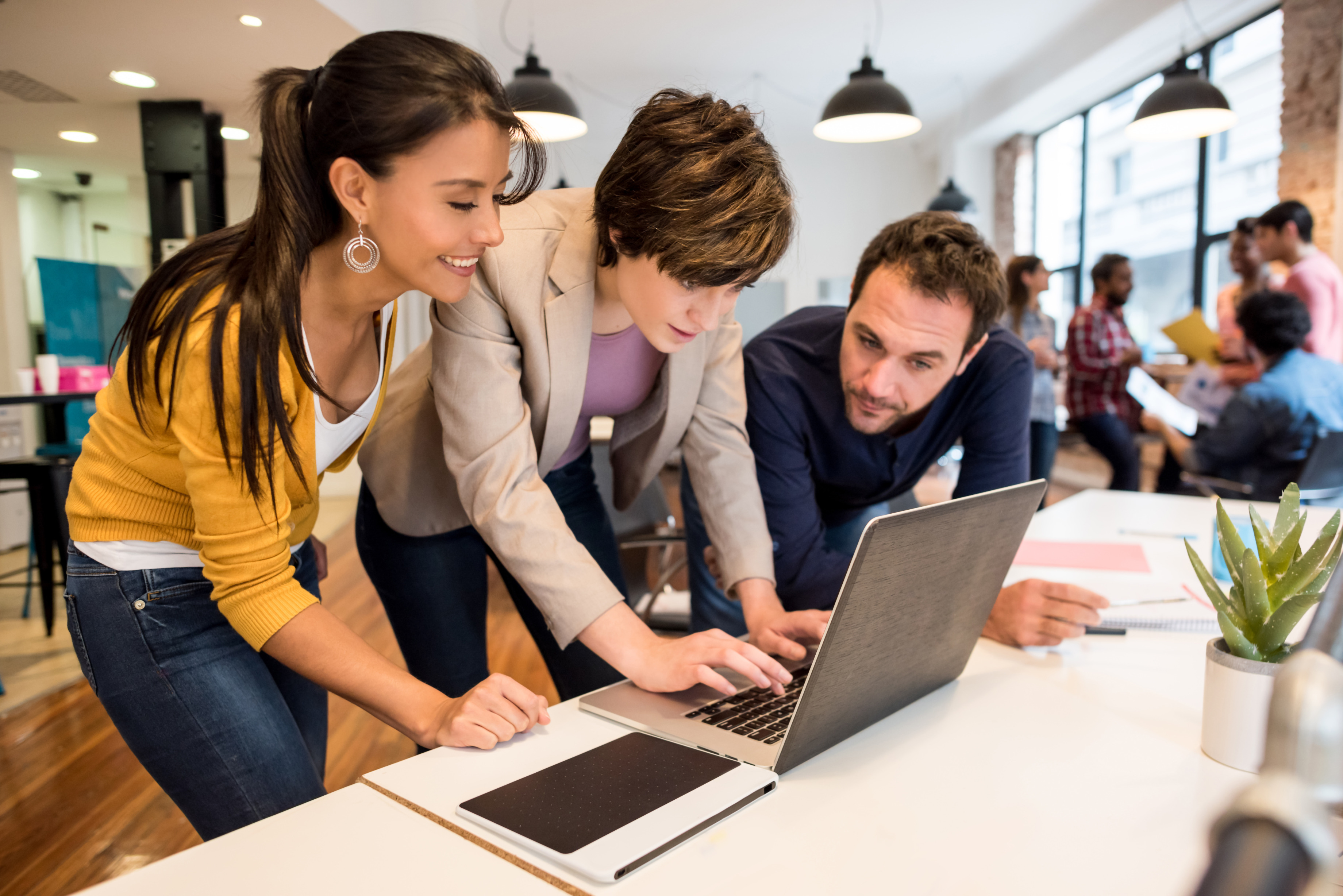 Group of people working at a laptop